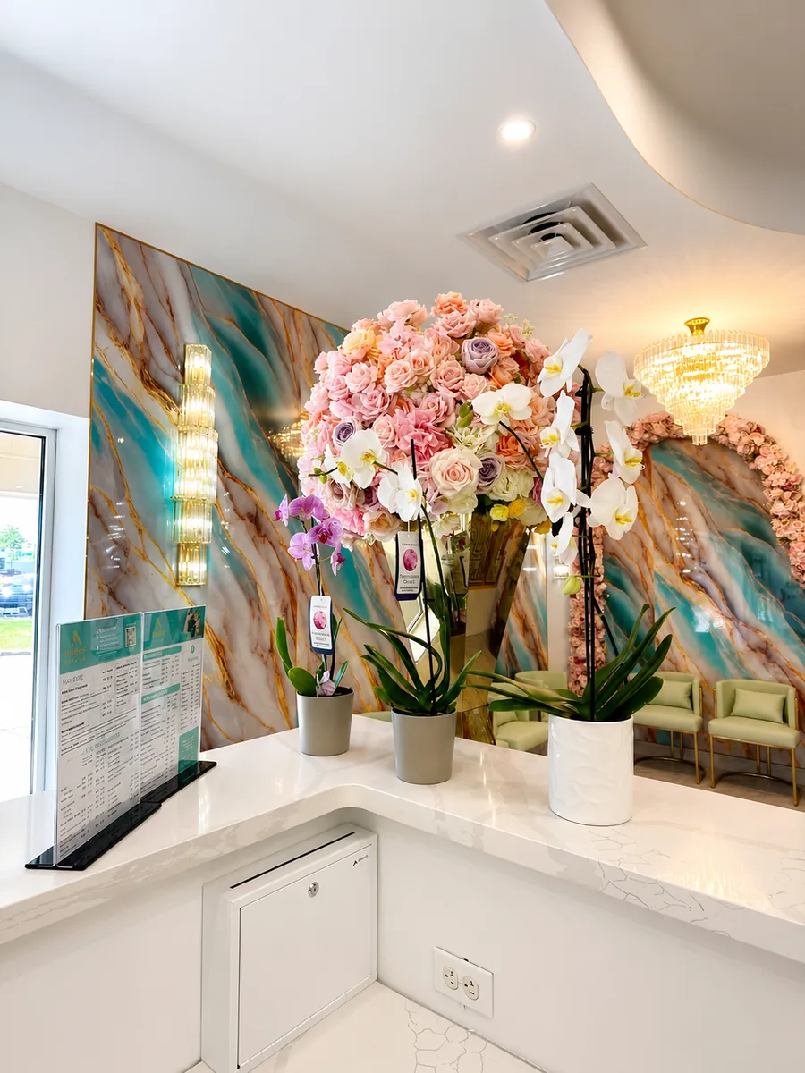 Amherst Nails reception desk with flower arrangements